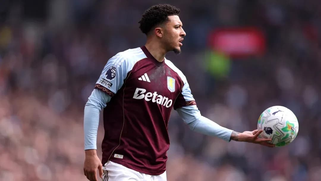 Player in Aston Villa kit preparing to throw ball