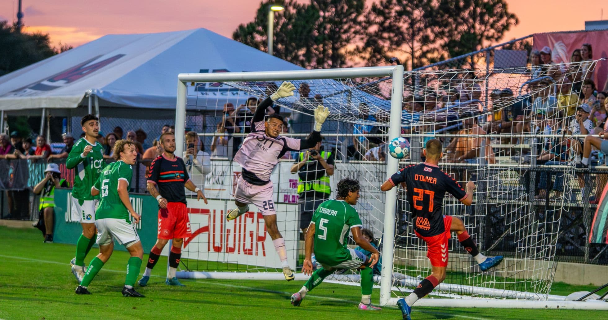 Goalkeeper attempting to block a shot on goal
