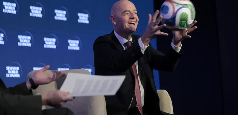Official holding a football at conference event