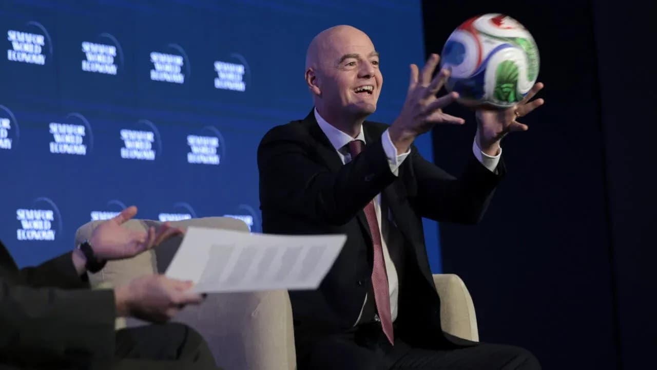 Official holding a football at conference event