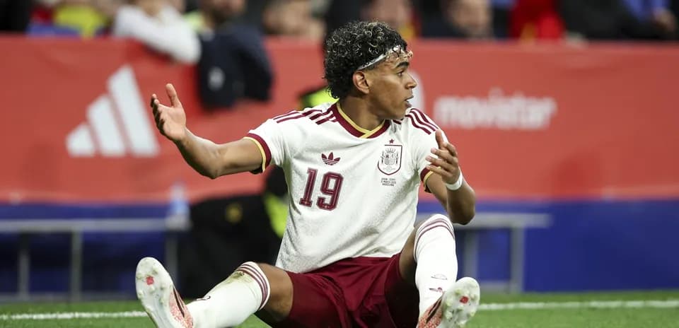 Spain player sitting on the field during match