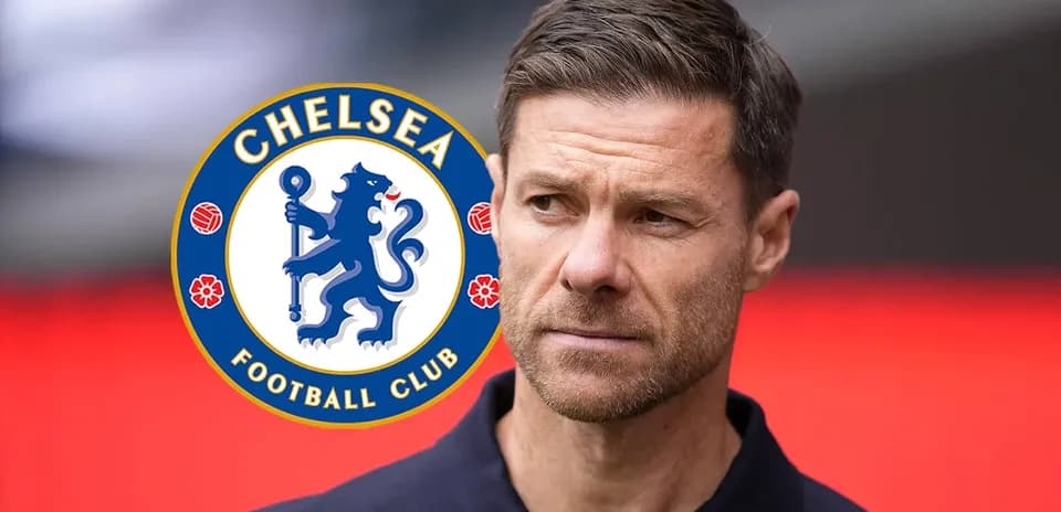 Coach in front of Chelsea FC logo backdrop