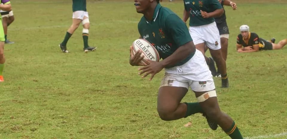 Player running with rugby ball during match