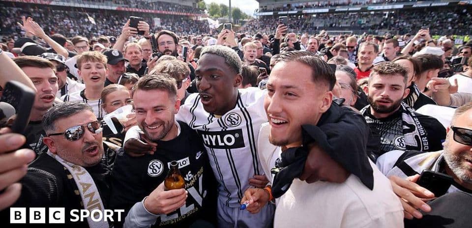 Fans celebrating with players after match victory