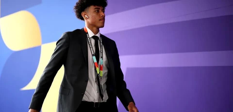 Player arriving in suit with FIFA World Cup lanyard