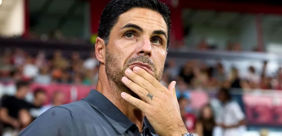 Coach observing match with thoughtful expression