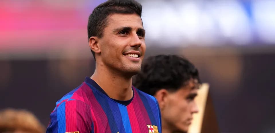 Football player smiling during trophy celebration event