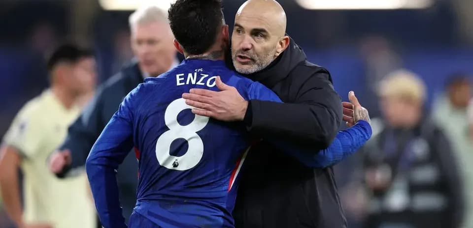 Coach embracing player Enzo after match
