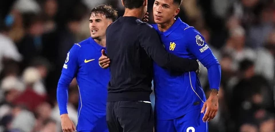 Players embracing coach after match on field