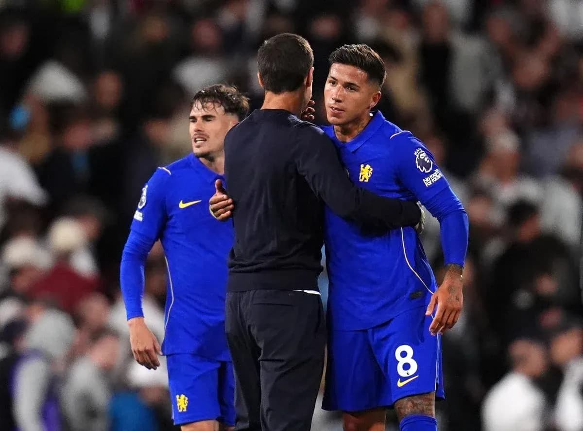 Players embracing coach after match on field