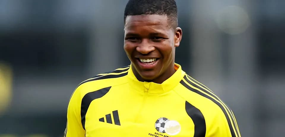 Player smiling in yellow training jersey