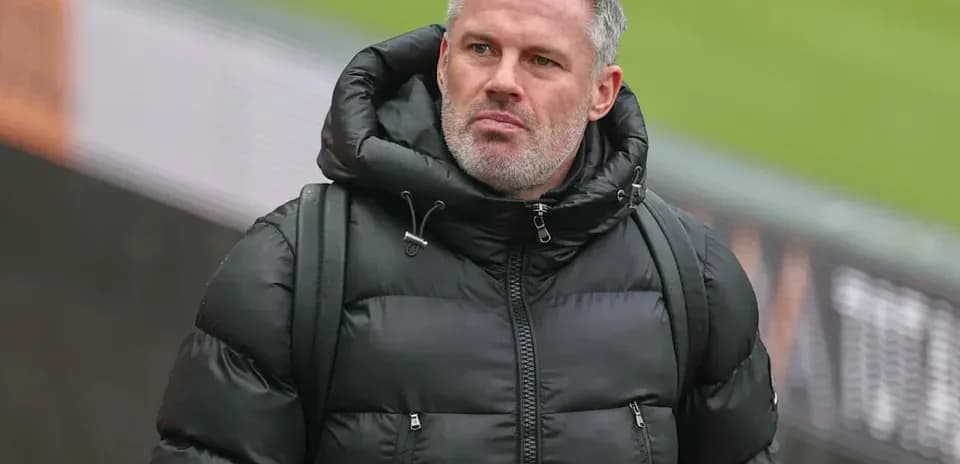 Man in black puffer jacket walking at stadium