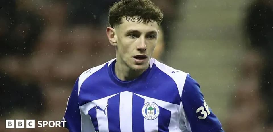 Player in Wigan Athletic kit during match action