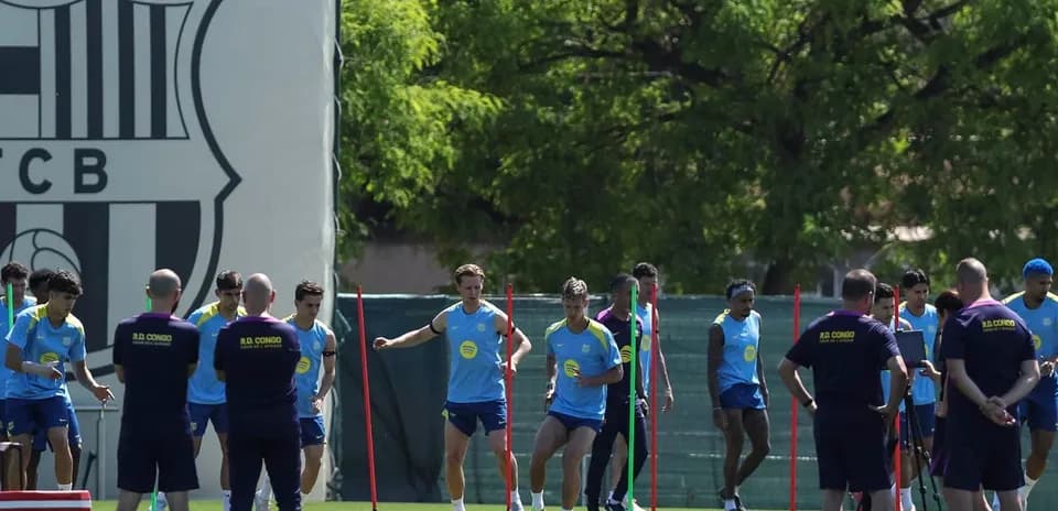 Barcelona players training on the pitch with cones