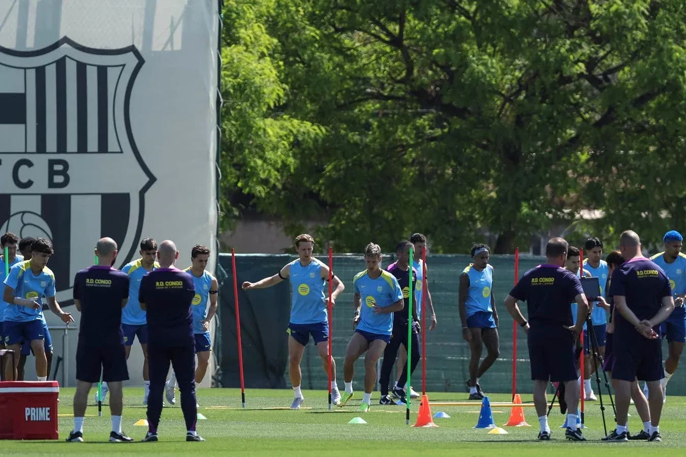 Barcelona players training on the pitch with cones