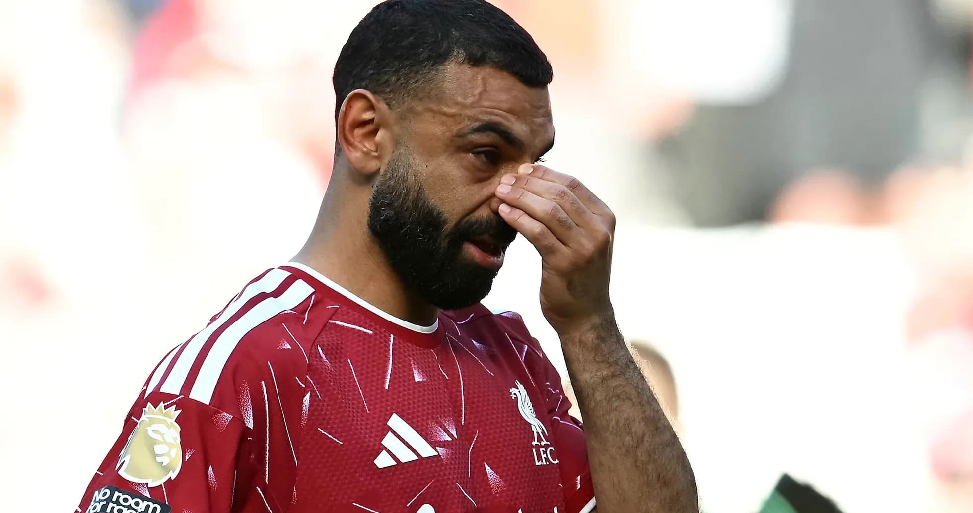 Player adjusting his face during match action