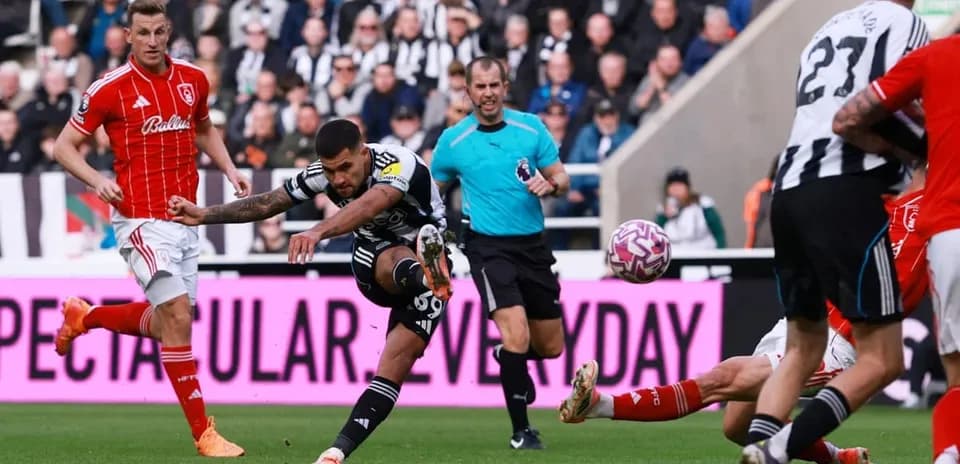 Newcastle player shooting at goal during match