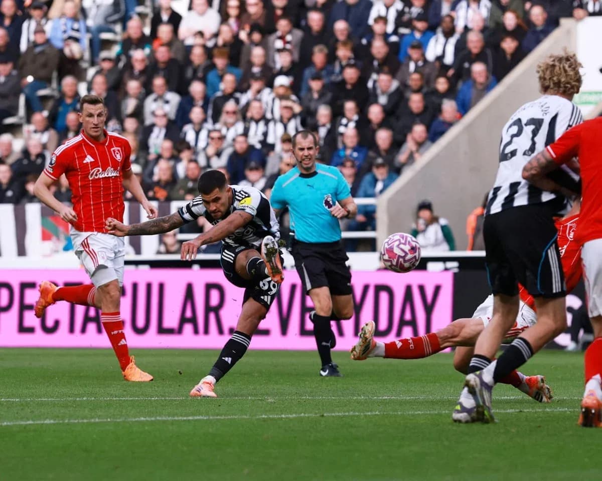 Newcastle player shooting at goal during match