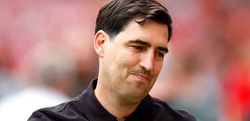 Coach during match, wearing black jacket