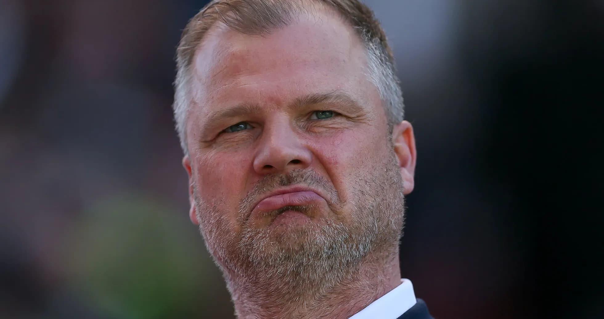 Man with a serious expression during match