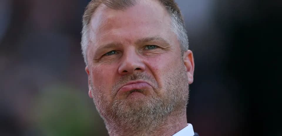 Man with a serious expression during match