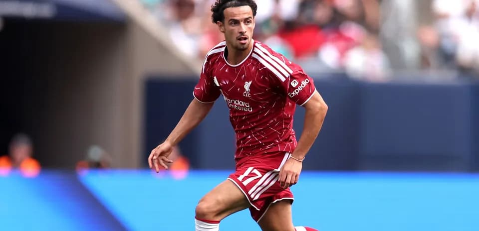 Player in red Liverpool kit running on the field