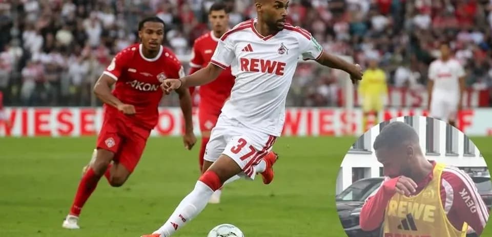 Player in white jersey dribbling the ball during match