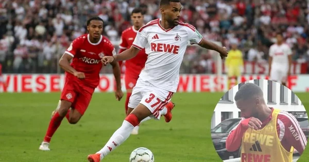 Player in white jersey dribbling the ball during match