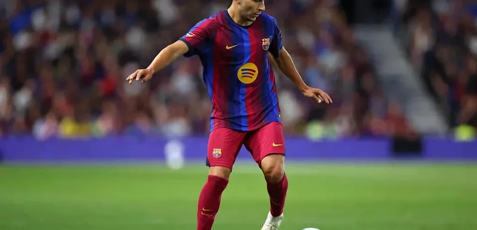 Barcelona player dribbling the ball on the field