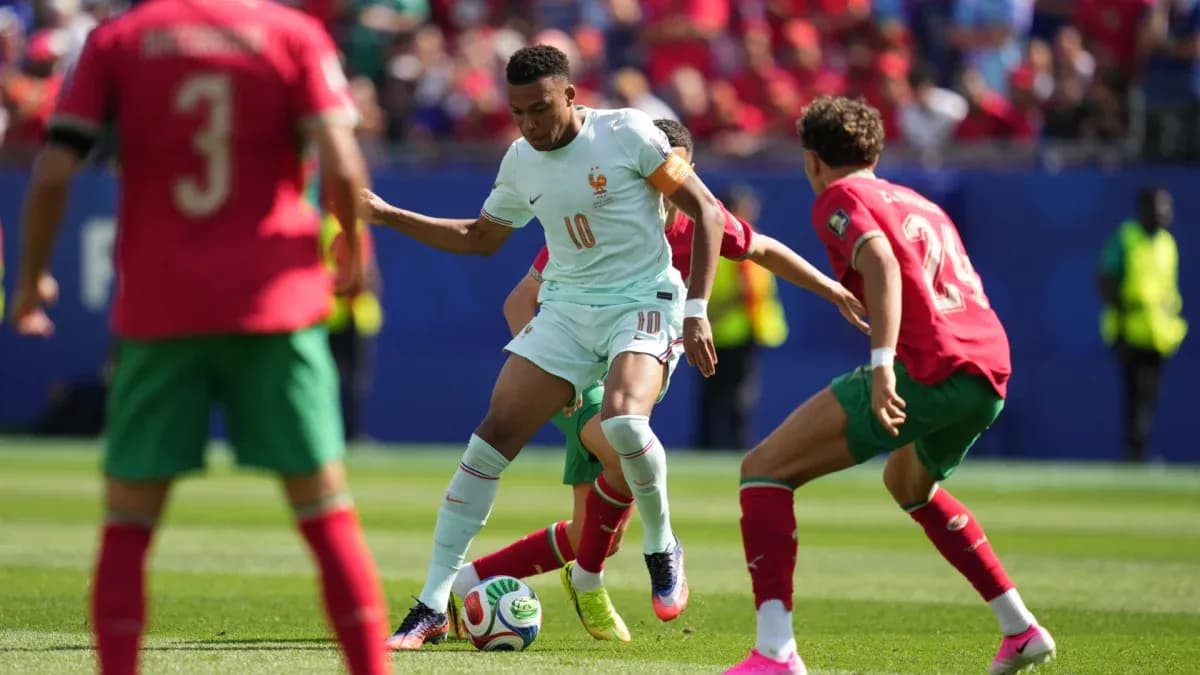 Player from France dribbling against Moroccan defenders