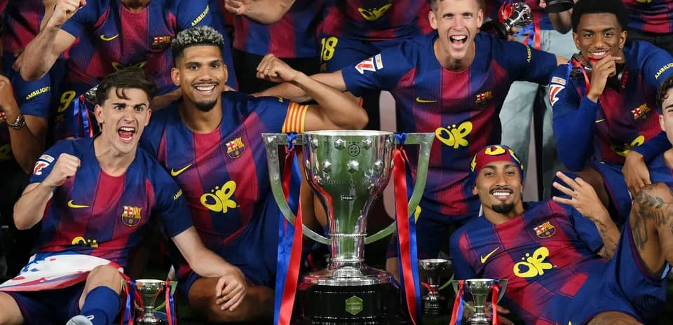 FC Barcelona players celebrating with trophies