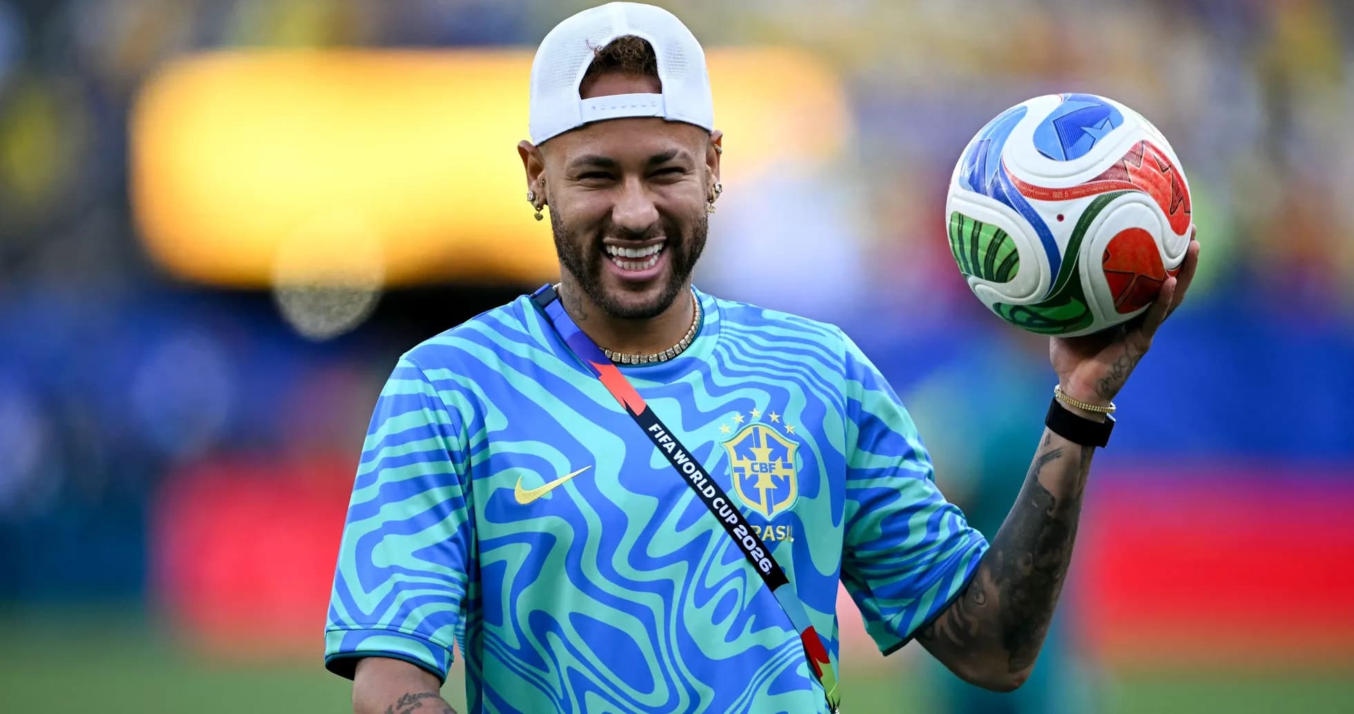 Player holding a football on the pitch