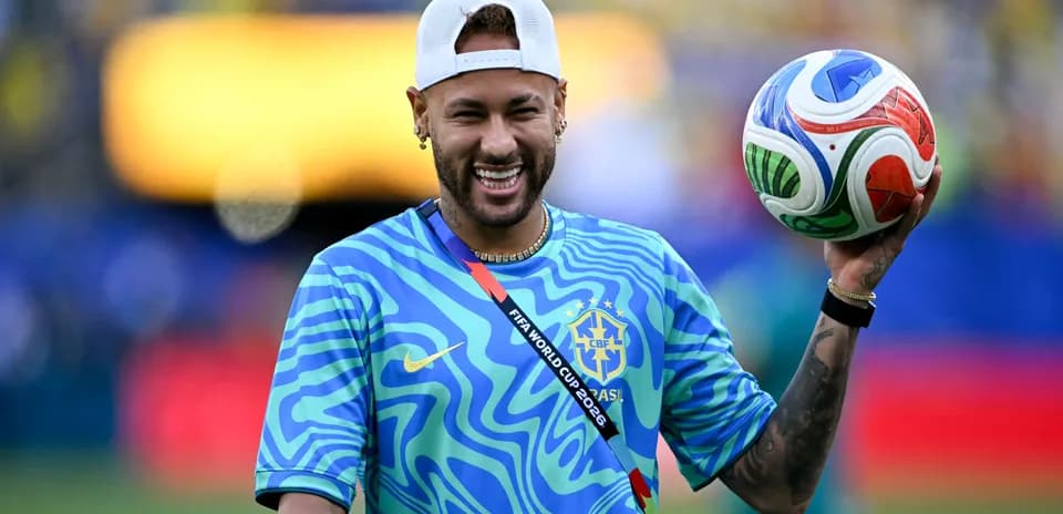 Player holding a football on the pitch