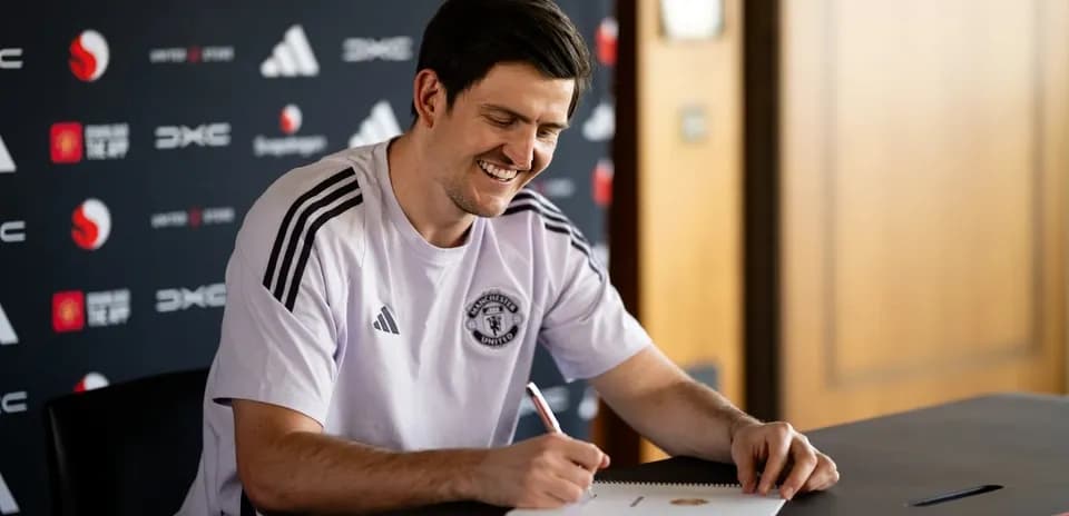 Player signing contract at press conference table