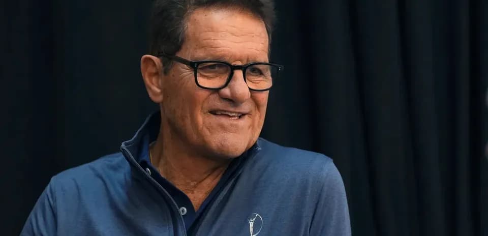 Man in blue jacket smiling during event