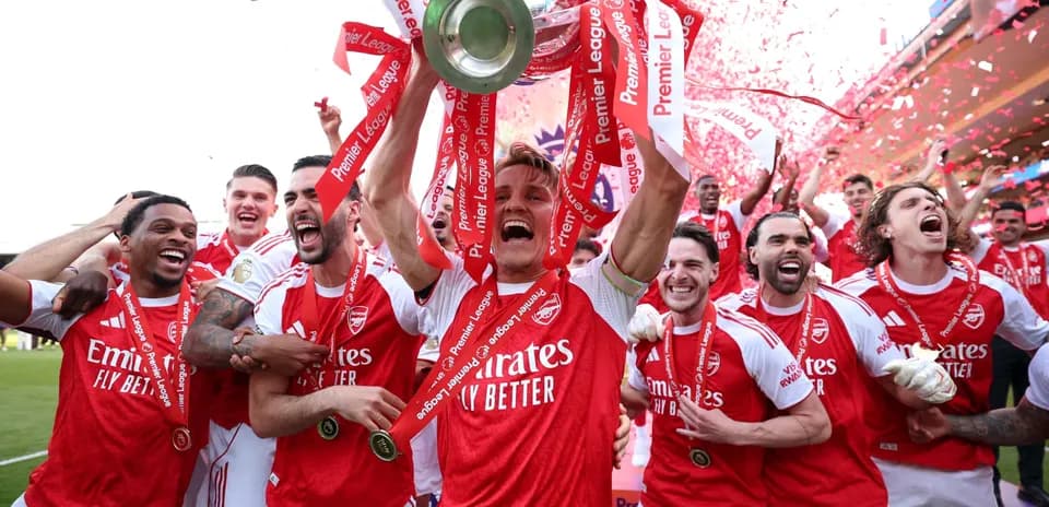 Arsenal players celebrating with Premier League trophy