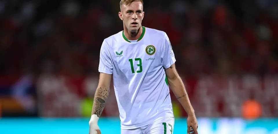 Player in white jersey walking on the pitch