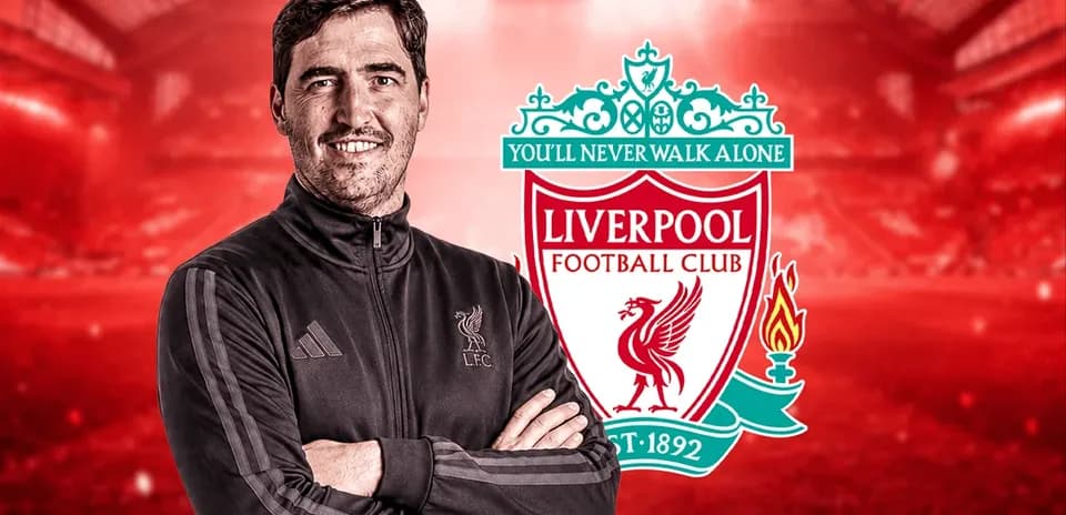 Man in training gear with Liverpool FC logo background