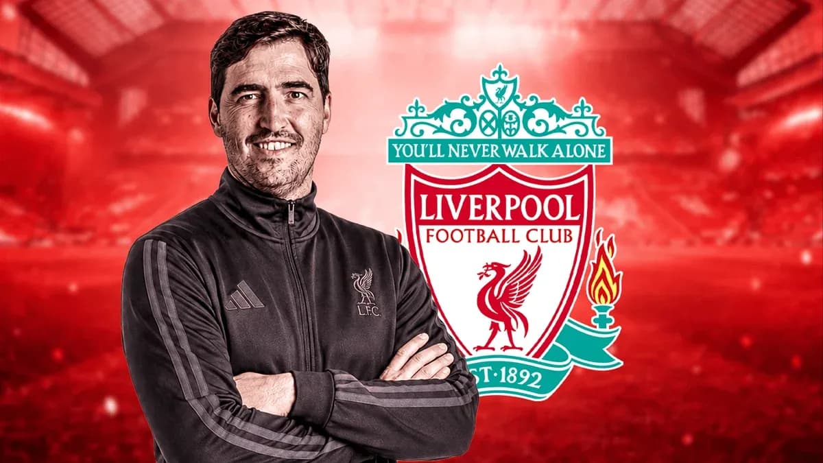Man in training gear with Liverpool FC logo background