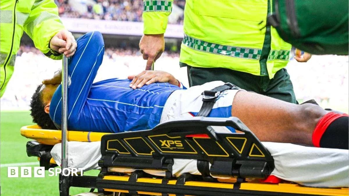 Player being treated on stretcher by medical staff
