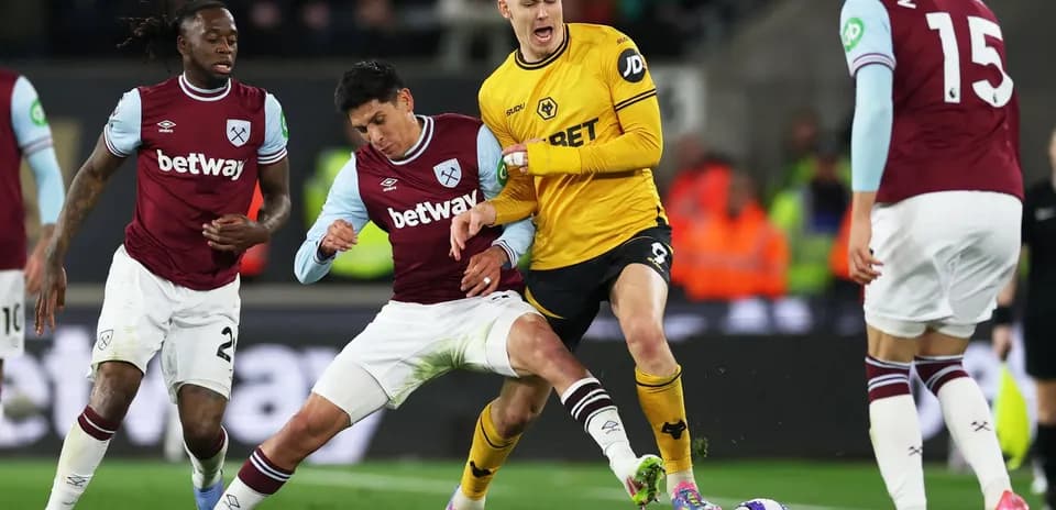 West Ham players challenging Wolves striker for the ball