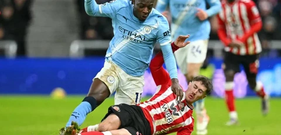 Player tackling opponent during football match