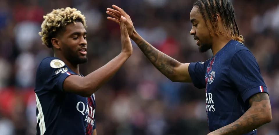 Two PSG players celebrating during a match
