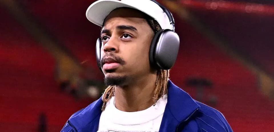Player wearing headphones walking in stadium