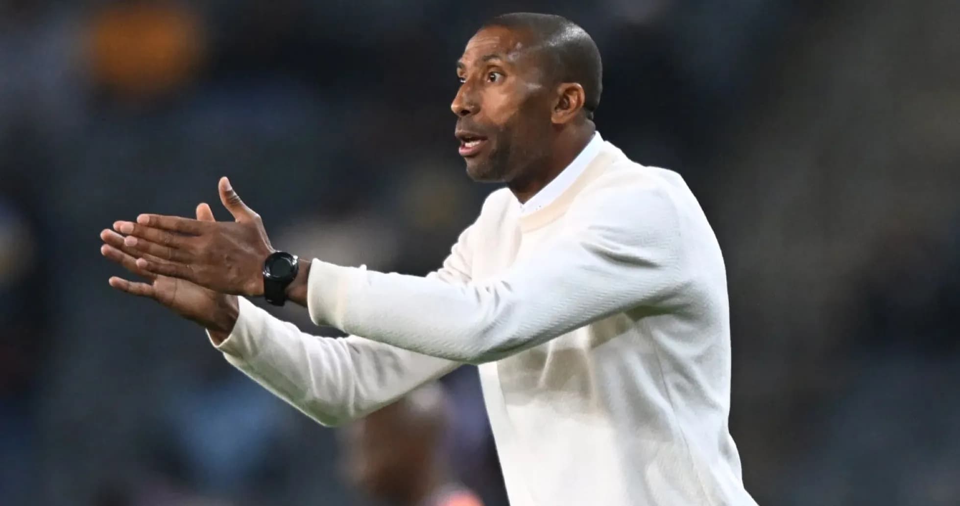 Coach gesturing during a football match on the sideline