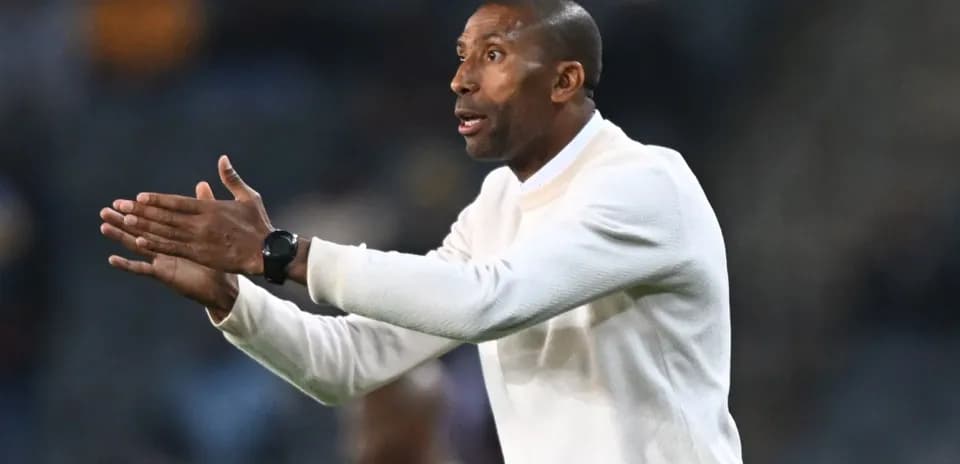 Coach gesturing during a football match on the sideline