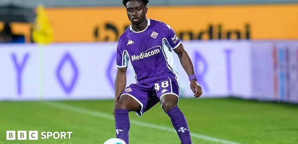 Player in purple kit preparing to pass the ball