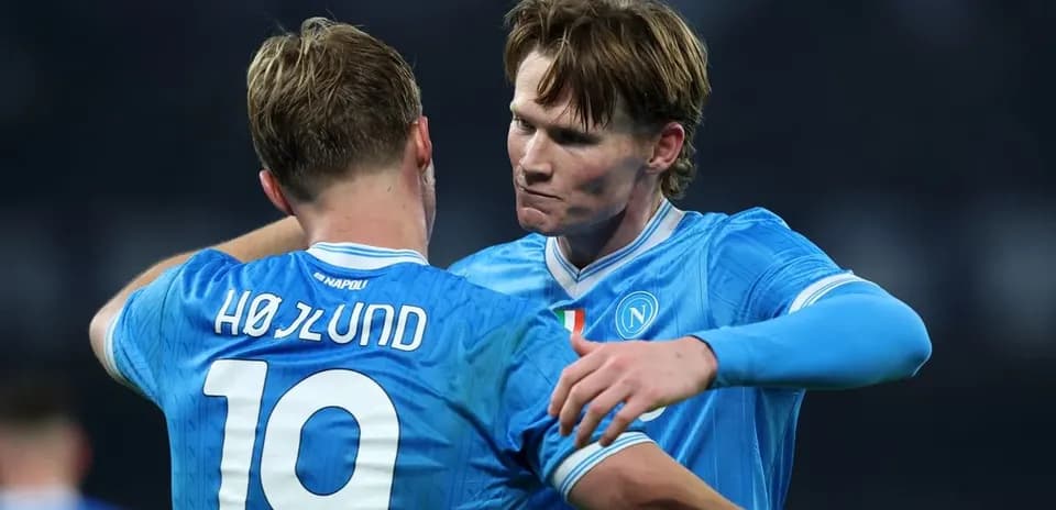 Two Napoli players embracing on the field
