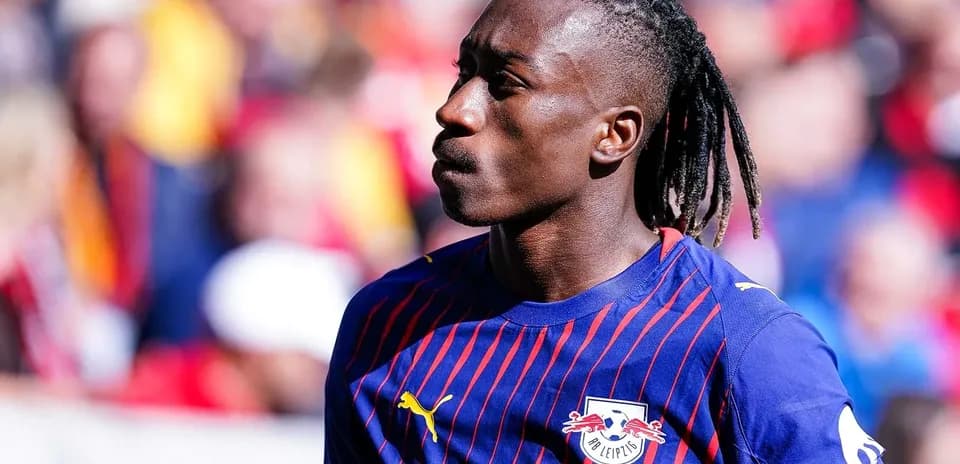 Player walking on the pitch in team jersey