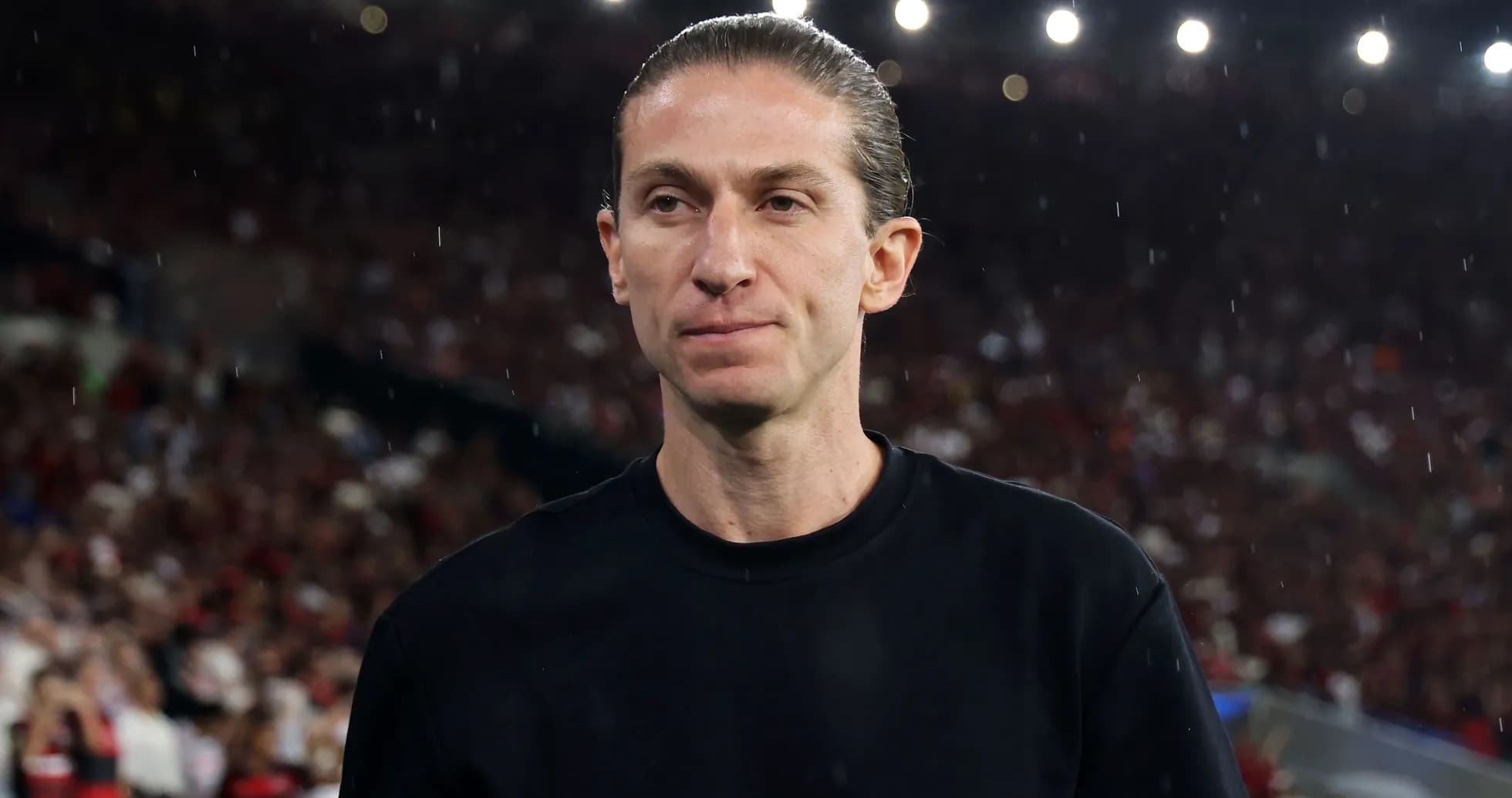 Coach on the sideline during a rainy match
